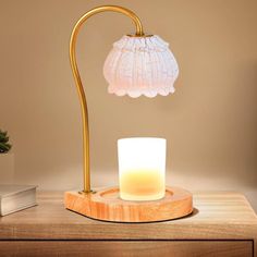 a table lamp with a lit candle on it