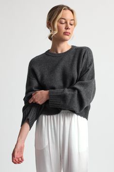 Crafted from luxurious, soft wool, this sweater combines warmth with a modern cropped silhouette. Elegant Wool Sweater For Loungewear, Chic Cropped Sweater With Ribbed Cuffs For Winter, Modern Wool Sweater With Ribbed Cuffs, Fine Knit Fall Loungewear Sweater, Fine Knit Sweater For Fall Loungewear, Fine Knit Loungewear Sweater For Fall, Fall Fine Knit Loungewear Sweater, Chic Wool Sweater For Layering, Chic Merino Wool Tops With Ribbed Cuffs