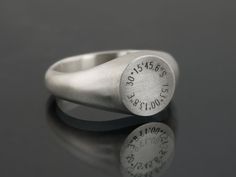 This Signet Ring engraved with personalised coordinates is a timeless symbol of individuality and connection.  At its heart lies the engraving of coordinates that hold profound meaning to you. Whether it's the exact location of your cherished memories -- a childhood home, a favourite vacation spot, or the place where love blossomed -- these coordinates serve as a tangible reminder of the moments and places that shape your journey. The design of the ring is timeless and works to be gender neutral Symbolic Formal Engraved Ring, Minimalist Jewelry With Hallmarks For Anniversary, Timeless Jewelry For Anniversary With Hallmarks, Symbolic Engraved Jewelry For Anniversary, Modern Engraved Round Band Jewelry, Modern Engraved Jewelry With Round Band, Symbolic Stamped Signet Ring For Anniversary, Classic Hallmarked Engraved Ring For Commemoration, Classic Engraved Hallmarked Ring For Commemoration