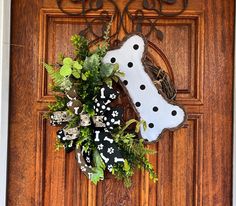 a dog bone wreath is hanging on the front door