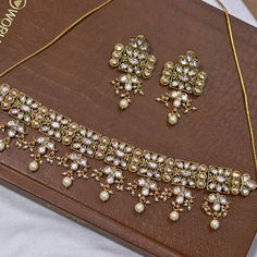 About: Enhance your style with our Designer Gold Plated Royal Kundan Necklace. This elegant set comes with matching earrings to complete your look. The intricate design and gold plating add a touch of royalty to any outfit. Perfect for weddings, parties, or any special occasion. Details: Eye-catching and unique jewelry that will set you apart. Gift this piece to a loved one, and see their face light up with joy. Best for gifting or for personal use, wear it to any occasion and become the spotlig Bollywood Meenakari Jewelry Sets For Formal Occasions, Bollywood Style Meenakari Jewelry Set For Formal Occasions, Festive Jewelry Sets With Matching Earrings For Diwali, Diwali Jewelry Sets With Matching Earrings For Celebration, Diwali Celebration Jewelry Sets With Matching Earrings, Gold Hand-set Kundan Necklace For Celebration, Gold Hand Set Kundan Necklace For Celebration, Gold Chandbali Jewelry Sets Hand Set, Gold Plated Chandbali Jewelry Sets For Celebration