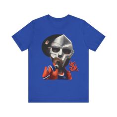 Elevate your style with our exclusive MF Doom shirt. Crafted for true hip hop fans, this tee merges comfort with swag. Embrace the vibes of this rap legends and make a statement wherever you go. This classic unisex jersey short sleeve tee fits like a well-loved favorite. Soft cotton and quality print make users fall in love with it over and over again. These t-shirts have-ribbed knit collars to bolster shaping. The shoulders have taping for better fit over time. Dual side seams hold the garment's shape for longer.  .: 100% Airlume combed and ringspun cotton (fiber content may vary for different colors) .: Light fabric (4.2 oz/yd² (142 g/m .: Retail fit .: Tear away label .: Runs true to size Pop Culture Streetwear Shirt With Letter Print, Streetwear Pre-shrunk Tri-blend T-shirt, Pre-shrunk Tri-blend T-shirt For Streetwear, Tri-blend Band Merch T-shirt For Streetwear, Tri-blend T-shirt For Streetwear Band Merch, Pop Culture Streetwear Shirt With Front Print, Pop Culture Front Print Shirt For Streetwear, Urban Style Tri-blend Pre-shrunk Tops, Pop Culture Tops For Summer Streetwear