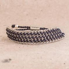 Forming a bold mail, metal chain is linked together to form this wristband bracelet that exudes strength. Wakami presents this bracelet, promoting Guatemalan handicrafts. The chain is accented by navy macrame cord that is carefully knotted by hand through the links. This bracelets adjusts with a sliding bead that reads "Strength." Casual Silver Adjustable Chain Bracelet, Casual Adjustable Chain Bracelet, Everyday Metal Bracelets With Sliding Knot, Adjustable Metal Jubilee Braided Bracelets, Handmade Silver Wrap Bracelet For Friendship, Adjustable Silver Chain Friendship Bracelet, Adjustable Silver Chain Bracelet For Friendship, Silver Hand Wrapped Bracelets For Friendship, Nickel-free Silver Braided Bracelet For Friendship