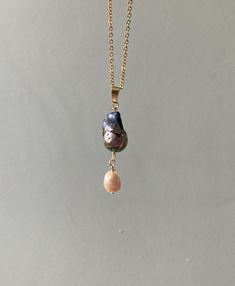 Iridescent, rainbow shifting black flameball pearl pendant, suspending a palest pink pearl teardrop. On an 18inch 18k gold plated chain necklace.  Unique, one of a kind Briolette High Luster Pearl Necklace Gift, High Luster Briolette Pearl Necklace As Gift, High Luster Briolette Pearl Necklace For Gift, Long Drop Pearl Charm Necklace As Gift, Drop Pearl Pendant Necklace, Long Drop Pearl Charm Necklace For Gift, Gift Long Drop Pearl Charm Necklaces, Pink Pearl Charm Pendant Necklaces, Baroque Pearl Drop Necklace With Pearl Pendant