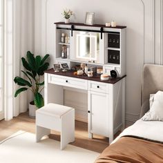 a bedroom with a bed, desk and mirror