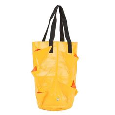 a yellow tote bag with black handles and an orange leaf design on the front