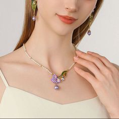 Elevate your style with our Iris Flower Pearl Necklace. The fabulous iris flower pendant, delicate enamel finish, and shinning gemstones add glamour to any outfit. The iris, with its vibrant colors and graceful sway, is a messenger of love and longing, resembling freedom, wisdom, glory, and romance. In Greek mythology, it is the rainbow goddess, and a symbol of royal power in France. A pearl chain with gentle natural allure complements the sophisticated design, making it a dreamy addition to you Elegant Enamel Flower Shaped Jewelry, Elegant Enamel Wedding Necklaces, Elegant Enamel Flower Pendant Jewelry, Elegant Enamel Jewelry With Gemstone, Flower-shaped Enamel Jewelry For Wedding, Flower Shaped Enamel Jewelry For Wedding, Enamel Flower-shaped Jewelry For Wedding, Flower Shaped Enamel Wedding Jewelry, Enamel Flower Shaped Wedding Jewelry