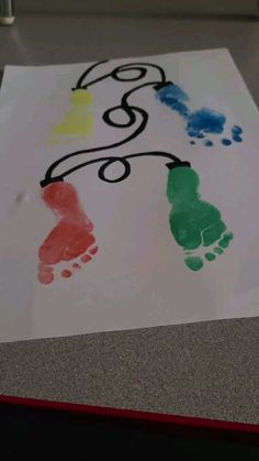 the child's hand and foot prints are painted on paper with colored inks