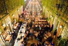 an overhead view of a restaurant with lots of people sitting at tables and eating food