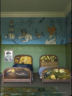 two beds in a room with green walls and paintings on the wall behind them,