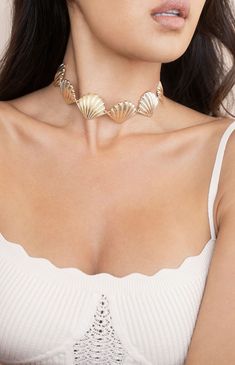 Online only! Turn heads with Ettika's Scallop Shell Body Chain, featuring a striking seashell design that drapes elegantly across the body. The gold finish adds a touch of luxury, making it a standout accessory for any occasion.


	Gold Tone, Zinc
	31" with 7" extender
	Lobster Clasp Ocean-inspired Metal Jewelry, Elegant Metal Jewelry For Beach, Elegant Shell Jewelry For Parties, Elegant Shell-shaped Metal Jewelry, Gold Summer Choker, Elegant Shell-shaped Necklace With Clavicle Chain, Ocean-inspired Gold Jewelry For Party, Shell-shaped Clavicle Chain Necklace, Elegant Shell Necklaces For Summer