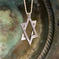 This Exceptional Interlocking Star of David Pendant is an extraordinary silver masterpiece combining spiritual significance and unique design.  This captivating pendant, crafted with meticulous detail, features two interlocking parts forming the sacred Star of David and is adorned with the timeless Priestly Blessing. The pendant proudly displays the Priestly Blessing:  "May God bless and guard you. May God show you favor and be gracious to you. May God show you kindness and grant you peace." The Spiritual Engraved White Gold Jewelry, Engraved Spiritual White Gold Jewelry, Engraved White Gold Spiritual Jewelry, Spiritual Silver Necklace With Engraving Option, Spiritual Sterling Silver Etched Necklaces, Spiritual Etched Sterling Silver Necklaces, Symbolic Etched Jewelry For Blessing, Spiritual Etched Sterling Silver Necklace, Sterling Silver Star Of David Necklace For Anniversary