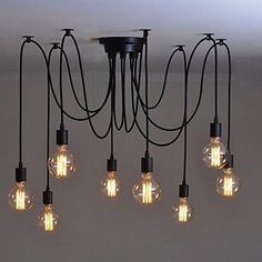 a bunch of light bulbs hanging from a ceiling