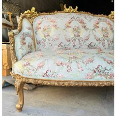 an ornately decorated couch sitting on top of a floor