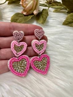 Fall in Love with Our Sweetheart Pink Triple Heart Dangles! 💖✨ Embrace the romance, charm, and fun of these stunning Sweetheart Pink Triple Heart Dangle Earrings. Perfect for adding a touch of love and elegance to any outfit, these earrings are designed to bring a playful and enchanting vibe to your jewelry collection. ✨ Features: Adorable Design: Each earring features three beautifully crafted hearts in varying shades of pink, delicately linked to create a cascading effect that captures attent Trendy Dangle Heart Earrings For Valentine's Day, Fun Pink Heart-shaped Jewelry, Sweet Pink Jewelry With Heart Beads, Sweet Pink Dangle Heart Earrings, Sweet Pink Heart Dangle Earrings, Cute Pink Double Heart Jewelry, Sweet Pink Heart-shaped Earrings, Sweet Pink Drop Earrings, Fun Pink Earrings For Pierced Ears