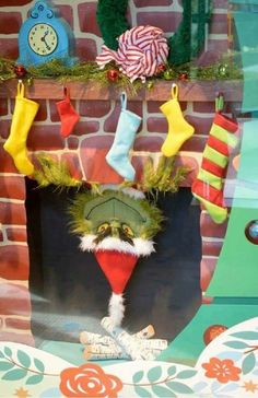 a christmas display with stockings and socks hanging from the fireplace