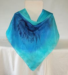 This square silk scarf measures 35 by 35 inches or 90 by 90 centimeters. It has hand rolled and hand stitched edges into which I sew my own label. The scarf is large enough to wrap around the head or wear around the shoulders. I sprayed navy blue,royal blue and turquoise steam fix dyes on ponge 5 silk. I then dropped salt onto the wet dye. When heat is applied the salt pulls the dye into a unique pattern. The scarf is then steamed to fix the dye. The scarf is hand washable and washing instructio Bohemian Blue Silk Scarf As Gift, Handmade Blue Scarves As Gifts, Blue Square Scarves As Gift, Handmade Blue Scarf As A Gift, Bohemian Blue Silk Scarf For Gift, Bohemian Blue Silk Scarf Gift, Blue Square Scarves For Gifts, Bohemian Blue Hand Painted Silk Scarf, Artistic Handmade Blue Silk Scarf