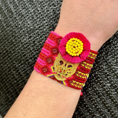 Bring the vibrant energy and handmade charm of Oaxaca, Mexico to your own wrist with our Woven Bracelet with Calaca Charm. This stunning piece combines the traditional techniques of Oaxacan weaving with the whimsy of boho-inspired fashion. Every bracelet is handwoven by skilled artisans in Oaxaca, using vibrant and durable threads that create intricate patterns and cheerful colors. The woven design adds texture and depth to the bracelet, allowing it to stand out from other accessories. The focal Mexican Calavera, Wool Knit Scarf, Handcrafted Boots, Painted Hats, Mexican Jewelry, Woven Bracelet, Camera Straps, Shoulder Backpack, Vibrant Energy