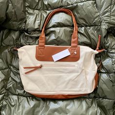 Brand New Weekender Bag. Canvas Material And Vegan Leather With Removable Crossbody Strap. Outside Zip Pocket. Dimensions: - 15” H X 15” L X 7” D - Bottom Pocket 15" L X 7" W X 4" H Accepting All Reasonable Offers. Bundle With Other Items For A Deal! On-the-go Beige Diaper Bag With Double Handle, Cream Satchel For On-the-go, Beige Weekender Bag With Leather Handles, Beige Weekender Bag With Double Handle For Daily Use, White Weekender Bag With Zipper For Daily Use, Beige Double Handle Weekender Bag For Daily Use, Beige On-the-go Diaper Tote Bag, Chic Beige Shoulder Weekender Bag, Casual Beige Diaper Bag With Removable Pouch