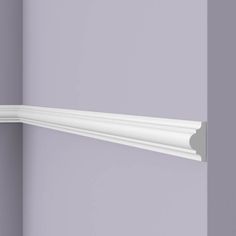 the corner of a wall with a white crown molding on it's edge