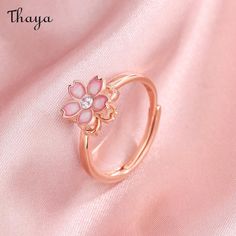 Capture the essence of cherry blossom season with our Silver Sakura Spinner Ring. This elegant piece tells a story of beauty and renewal, as delicate petals bloom and dance in the breeze. The spinner design allows for a soothing sensation, perfect for those seeking balance and serenity in their daily lives. Elevate your style with this stunning symbol of hope and new beginnings.   - Brand: Thaya  - Material: S925 Silver  - Weight : About 2.34g  - Size: Stack Mouth 14th  - Style: Flower  - Gender: Women Pink Ring Aesthetic, Cherry Blossom Clothes, Sakura Accessories, Kawaii Rings, Sakura Jewelry, Sakura Ring, Spinning Jewelry, Kawaii Ring, Cherry Blossom Jewelry