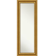 a gold framed mirror on a white wall