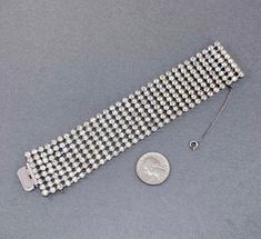 "This sparkling clear stone bracelet is such a beauty. It is silver (base metal silver/white metal) with a rhodium plate, and dates probably from the 1950s. It is beautiful clear rhinestones, 8 rows wide. Simple style, yet very elegant and gorgeous! Marked: Unsigned.... maybe Kramer or Weiss? Measurements: 7\" x 1.38\" wide. Fastens with a push in box clasp. Condition: Beautiful vintage condition. Stones are brilliant and sparkly. They are NOT dark or yellow like it may appear in some of the pic 1950s Bracelet, Vintage Rhinestone Jewelry, Book Pieces, Wide Bracelet, Wedding Jewelry Bracelets, Box Clasp, Expensive Jewelry, Clear Stone, Rhinestone Bracelet