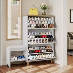 a white shoe rack with several pairs of shoes on it and a mirror in the corner