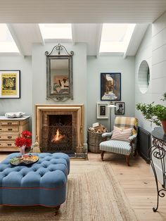 a living room filled with furniture and a fire place in the middle of the room