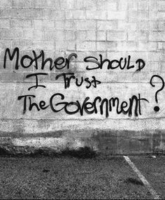 graffiti on the side of a building reads, mother should i trust the government?