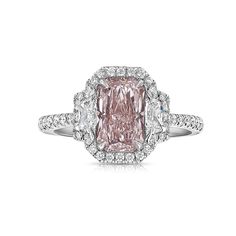 a pink diamond ring with diamonds around it