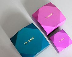 two boxes with the word vanity on them are sitting next to each other in different colors