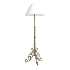 a floor lamp with a white shade on it's base and a metal stand