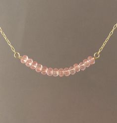 Pretty pink cherry quartz stones line up in a row and hangs on a 14k gold fill, 14k rose gold fill, or sterling silver chain. Stones measure approx 1.5 inches lined up. You can choose the length you want when you checkout. If you want a size smaller than 16 inches, let me know when you checkout. You can add an extension chain to your necklace by adding this item to your cart: https://www.etsy.com/listing/182425506/add-on-extension-chain-gold-fill-or Item comes packaged in a little brown box. Pearl Jewelry Gift, Pearl Strands Necklace, Cherry Quartz, Pearl Necklace Earrings, Pink Rose Quartz, Silver Bead Necklace, Cultured Pearl Necklace, Gemstone Beaded Necklace, Gold Bead Necklace