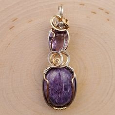 Charoite and faceted Amethyst, handset in Sterling Silver and 14k Goldfill by me!49mm in length Moldavite Stone, Wire Wrap Pendant, Necklace Amethyst, Phantom Quartz, Amethyst Necklace, Amethyst Pendant, Labradorite Pendant, Wrapped Pendant, Necklace Sterling Silver