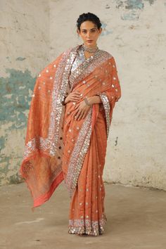 Indulge in luxury with this handcrafted tusser silk sari, featuring a statement border in metallic silver created using age-old hand embroidery techniques such as applique, aari, and zardosi. The intricate craftsmanship adds a touch of elegance to the ensemble. Paired with a silver hand-embroidered blouse, meticulously crafted with metallic silver using applique and aari techniques Silver Fabric, Old Hands, Hand Woven Textiles, Silk Sari, Embroidery Techniques, Popular Culture, Embroidered Blouse, Indian Wear, Hand Embroidered