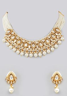 Featuring a Kundan Gold Pearl Necklace Set studded with Kundan stones adorned with faux diamonds in a tear drop pattern, set in mixed metal with gold plating. It is paired with a matching pair of earrings. Perfect for wedding and festive occasions. Composition : Mixed Metal Care: Avoid exposure to water and perfume. Store in dry plastic or fabric pouch. To clean, use a soft cloth to wipe the jewellery. Delivery : 6-8 weeks as the product is hand crafted. For more information and sizes please con Gold Necklace With Matching Earrings For Reception, Gold Teardrop Jewelry Hand Set, Gold Teardrop Jewelry Sets For Celebration, Temple Jewelry Teardrop Earrings For Celebrations, Gold Teardrop Jewelry With Hand Set Details, Gold Bridal Necklace With Gota Work For Celebration, Traditional White Teardrop Necklaces, Traditional White Teardrop Necklace, White Necklaces With Gota Work For Celebration