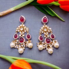 Silver Moissanite Polki Chandbali, Wedding Jewelery, Moissanite Polki Earring, Ruby Polki Earring, Ruby Earring, Wedding Jewellery, Chandbali *𝐀𝐛𝐨𝐮𝐭 𝐏𝐫𝐨𝐝𝐮𝐜𝐭* Product Code :-  TE 1014 Product Type :- Dangle Earring Product Weight :- 24.56 Gram Gemstone Used :- Moissanite, Labmade Ruby, Labmade Pearl Material :- 925 Starling Silver, Labmade Gemstones Size :- 6.5x2 Cm Intricate, hand-crafted, Pure Silver Polki Earrings, studded with high-quality Moissanite Polki comes with Push back, made in 92.5 silver with 22ct gold plating. The product comes with 92.5 silver stamping -Product can be made in gold as well. -If any product is not ready, It takes 2-3 weeks to make in pure silver -We also look forward to Bulk Orders. We shall consider special discount on Bulk Orders. Navrii (TM) by Temple Jewelry Chandelier Earrings For Wedding, Temple Jewelry Style Chandelier Earrings For Reception, Elegant Wedding Chandelier Earrings With Stone Work, Temple Style Chandelier Earrings For Reception, Intricate Design Chandbalis For Wedding, Fusion Style Kundan Bridal Earrings For Reception, Kundan Earrings For Reception, Elegant Pearl Earrings With Stone Work For Wedding, Elegant Kundan Danglers For Wedding