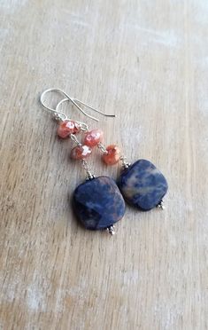 Sodalite Earrings Sterling Silver, Blue and Orange Earrings, Carnelian Earrings, Square Shaped Gemstone Dangle Earrings, Sunset Sodalite Dark indigo blue and orange sunset sodalite gemstones displaying lovely patterns dangle from mystic coated carnelian gemstones and sterling silver ear wires. The total length of the earrings is approximately 2 inches. The square orange sodalite gemstones are about 1/2 inch wide and 1/2 inch tall. They are faceted and polished on both sides. The blue and orange Sunset Sodalite, Blue Gemstone Earrings, Carnelian Earrings, Lapis Jewelry, Earrings Square, Orange Sunset, Orange Earrings, Red Bracelets, Garnet Earrings