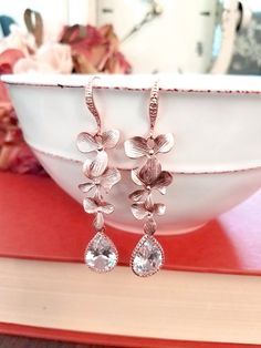 #dropearrings #dangleearrings #weddingearrings #bridalearrings #bridesmaidjewelry #bridesmaidgift #christmasearrings #lalacrystal #rosegoldjewelry #rosegoldearrings #orchidearrings #rosegoldorchid #holidaygift #gift for her Elegant Pink Gold Flower Earrings, Feminine Rose Gold Flower Earrings For Gift, Feminine Rose Gold Flower Earrings As Gift, Elegant Rose Gold Teardrop Earrings For Anniversary, Rose Gold Flower Earrings For Party, Rose Gold Earrings With Rose Flower Design, Formal Rose Gold Earrings With Rose Design, Elegant Flower Teardrop Earrings For Gift, Elegant Flower Shaped Teardrop Earrings