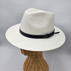 Panama Hat Indiana Style with leather strap, meticulously crafted to evoke timeless sophistication. Each strand woven with precision, it exudes vintage charm and unparalleled elegance, offering a stylish nod to a bygone era. This Panama hat was hand woven by skilled natives in Ecuador and it was carefully completed in Italy. Made from the fibers of the Toquilla Palm plant native to Ecuador. The hat gained international fame during the construction of the Panama Canal in the late 19th and early 2 White Flat Brim Fedora For Formal Occasions, Elegant Fedora With Curved Brim For Travel, Elegant Travel Fedora With Curved Brim, Elegant Curved Brim Fedora For Travel, White Panama Hat With Curved Brim For Formal Occasions, White Curved Brim Panama Hat For Formal Occasions, Formal White Panama Hat With Curved Brim, Classic White Wide Brim Fedora, Elegant Natural Panama Hat In Fedora Style