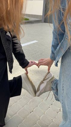 two girls are holding onto each other's shoes