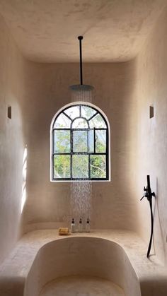 a bath room with a large tub and a window