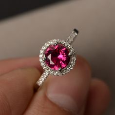 This is a gorgeous handmade creation. Its beauty is its simplicity & Elegance. The 7*7mm round cut lab created ruby is crafted in solid sterling silver and with rhodium plated. All item is sent in a beautiful gift box You can realize more lovely stuff clicking the link https://www.etsy.com/shop/knightjewelry?refshopsection_shophome_leftnav Please leave the correct address and you phone number for delivering successfully. Sterling Silver Ruby Ring With Center Stone, Classic Round Cut Lab-created Ruby Jewelry, Classic Ruby Ring With Halo Setting Gift, Classic Ruby Ring With Halo Design As Gift, Diamond Ring With Center Stone And Lab-created Ruby, Classic Round Crystal Birthstone Ring, Classic Pink Ruby Ring In Sterling Silver, Cubic Zirconia Ruby Ring With Halo Design, Elegant Round Garnet Crystal Ring