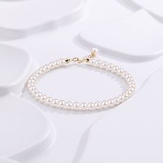 Embrace timeless grace with our Dainty Pearl White Freshwater Bracelet. Featuring delicate 4-5mm pearls, this bracelet captures a classic elegance that's both subtle and enchanting. Perfectly strung to rest effortlessly on your wrist, the small-sized pearls provide a refined touch that's suitable for any occasion. Whether worn alone or paired with other pieces, this dainty bracelet embodies pure sophistication. It's a beautiful reminder that true elegance often lies in simplicity. Pearl size 4-5 Elegant Adjustable Pearl Necklace With Round Beads, Pearl Bracelet With Pearl Charm For Formal Occasions, Elegant Round Beads Pearl Necklace With Adjustable Fit, Classic Gold Bracelet With Pearl Drop, Elegant Single Strand Yellow Gold Pearl Bracelet, Elegant Yellow Gold Single Strand Pearl Bracelet, Elegant Adjustable Bracelet With Pearl Drop, Elegant Hand-strung Pearl White Bracelet, Elegant White Gold Pearl Jubilee Bracelet