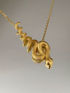 SNAKE NECKLACE This product is brass and gold plated. ♡ The most unique jewelry you can find, perfect gift for you and your loved one. ♡ All of our jewelry is handcrafted with enthusiasm and great care in our workshop. ► HOW TO CARE FOR YOUR JEWELRY * Maintain your jewelry's high shine by avoiding contact with any chemicals such as soap, perfume, lotion, makeup, hair & cleaning products. * Keeping your jewelry in a pouch or a box after using it will prolong the life of your jewelry. * Not recomm Symbolic Snake Chain Jewelry Gift, Unique Snake Chain Jewelry Gift, Snake-shaped Metal Necklace For Gift, Spiritual Brass Snake-shaped Jewelry, Spiritual Brass Jewelry In Snake Shape, Metal Snake Shape Necklace As Gift, Metal Snake-shaped Necklace For Gift, Gold-plated Snake Shape Jewelry, Gold Plated Snake Shape Jewelry