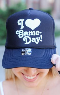 Get ready to score a fashion home run with our Love Game Days Trucker Hat! From the bleachers to the stadium, this trendy hat will keep you looking fly and showing team spirit! It's the ultimate game day accessory that can go with any outfit! Details: Soft, Trucker Hat 100% Polyester Features Front Graphic, White Lettering Color: Black One Size *OFFICIALLY LICENSED* Black OTTO Trucker Hat Adjustable Snap Back Comfortable Band on Inside for Forehead Baseball Cap For Tailgating During Baseball Season, Varsity Hats For Baseball Season, Black Trucker Hat With Letter Print For Baseball Season, Casual Snapback Hat For Baseball Season Fan Gear, Black Trucker Hat For Sports Events With Letter Print, Black Trucker Hat With Letter Print For Sports Events, Black Trucker Hat With Letter Print For Fans, Black Sports Fan Trucker Hat For Fan Merchandise, Black Sports Fan Trucker Hat