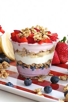 a dessert with fruit and yogurt is on a plate next to some bananas