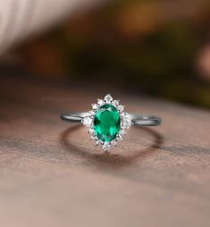 "MADE TO ORDER * Material: Solid gold(14K/18K white/yellow/rose gold) * DETAILS  57426 Engagement ring - Center stone:Lab Emerald 5*7 oval cut Side stone:Moissanite or diamond - diamond:0.2ct,Color G-H,Clarity SI-VS - moissanite:0.2ct * Click on the \"Pin It\" icon if you like this item * Custom Order We can make custom rings in almost any shape and style. If you want a specific model, please send us a clear picture and we will do our best.  * Shipping Most items take 2-3 weeks to create.I'm happy to rush your order, fees may apply, write me for details. * Payment Plans I offer payment plans. The minimum per payment will be $100. Write me your finger size, metal color, How much you would like to pay for the first payment. I will create a payment plan which will be customized specially for Emerald Engagement Ring Oval, Halo Emerald Engagement Ring, Oval Emerald Engagement Ring, Emerald Engagement Ring Vintage, Diamond Ring Women, Halo Engagement Ring Emerald, Vintage Emerald Engagement Ring, Unique Diamond Ring, White Gold Engagement Rings Vintage