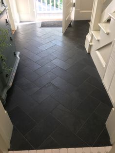 a black tile floor in a house with white trim